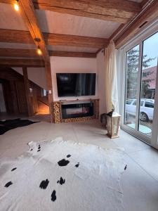 a living room with a flat screen tv on the wall at Landhaus 1868 in Villenbach