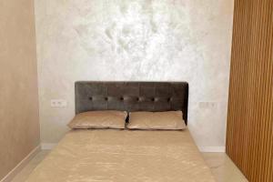 a bed with two pillows on it in a room at New luxury modern Apartment in Šnipiškės in Vilnius