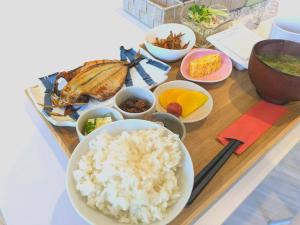 a tray with rice and other foods on a table at Villa FUN Kawana in Ito