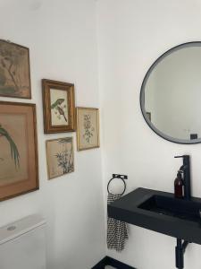 a bathroom with a sink and a mirror on the wall at Casa do Juiz in Barca da Amieira