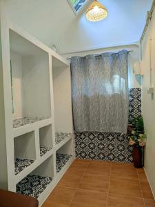 a bathroom with a shower with a shower curtain at Baan Suan Kayoo 2 Buffalo Bay Aow Khao Kwai in Ko Phayam +162 photos