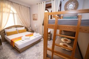 a bedroom with two bunk beds and a ladder at Sunrise Suite Olympiada - Luxury Beachfront Escape in Olympiada