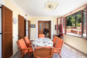 a dining room with a table and chairs at Krista House in Agios Gordios
