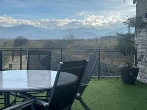 a table and chairs on a balcony with a view of mountains at The Underground MOOTEL in Porumbacu de Jos +31 photos