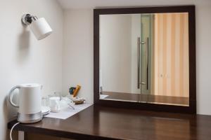 a bathroom vanity with a mirror and a sink at Pleasure Čair apartments in Niš +38 photos