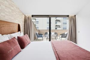 a hotel room with a bed and a balcony at GuestReady - Alma Invicta in Porto +22 photos