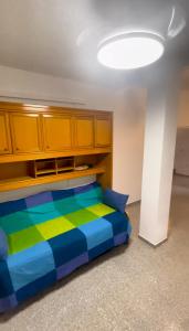 a bedroom with a colorful bed and wooden cabinets at Villa Familia in Écija +29 photos