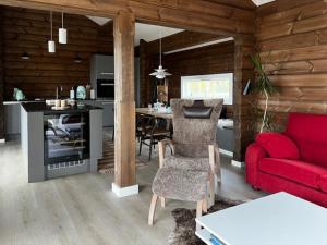 a living room with a red couch and a kitchen at Mountain Cabin With Great Ski Terrain in Vingelen