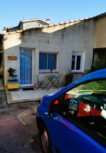 a blue car parked in front of a house at La ruchette in Riez