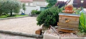 a garden with a small tree and a house at La ruchette in Riez
