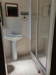 a bathroom with a sink and a shower at Hibiscus B&B in Strand +27 photos