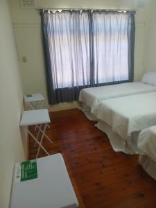 a room with two beds and a window at 16 Laburnum lodge in Durban +91 photos