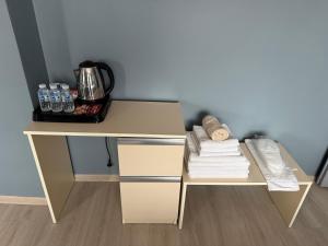 a desk with a pile of towels and water bottles at Flora Otel 16 rooms in Edirne