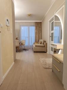 a living room with a couch and a table at Apartament Osiedle Piano Park Suwałki in Suwałki