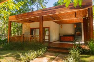 a home with a porch with a wooden deck at casa refugio das bromelhas in Itacaré +8 photos