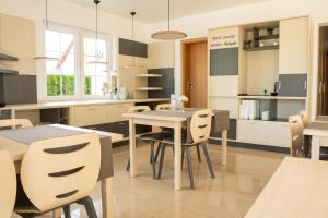a kitchen and dining room with a table and chairs at Aneta in Grzybowo