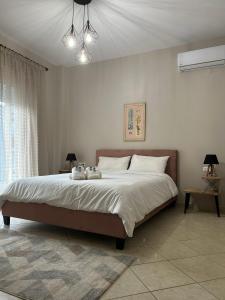a bedroom with a large bed with white sheets at Dream House by Lifehouses at Katerini in Katerini