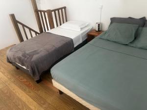 two beds sitting next to each other in a room at Les lodges couleur caraïbes in Saint-François