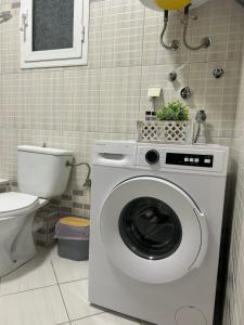 a washing machine in a bathroom with a toilet at Dream House by Lifehouses at Katerini in Katerini