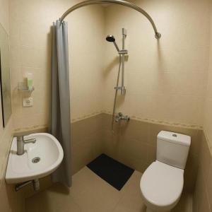 a bathroom with a toilet and a sink and a shower at Americana By California in Yerevan +9 photos