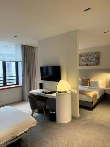 a hotel room with two beds and a desk and a bed at OPO Hotel in Brussels +70 photos