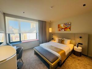 a hotel room with a bed and a table at OPO Hotel in Brussels