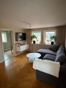 a living room with a couch and a table at Mysig stuga Buared - Family nature stay in Varberg