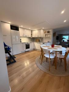 a kitchen and dining room with a table and chairs at Mysig stuga Buared - Family nature stay in Varberg