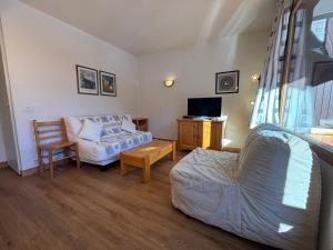 a living room with a couch and a chair at Résidence Saboia Clés Blanches in La Tania