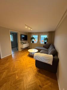 a living room with a couch and a table at Mysig stuga Buared - Family nature stay in Varberg +3 photos