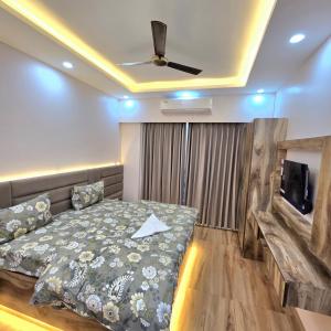 a bedroom with a bed and a flat screen tv at Anantya Inn in Greater Noida