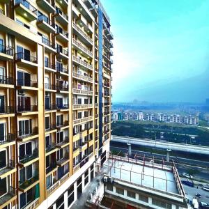 a tall building with balconies on the side of it at Anantya Inn in Greater Noida