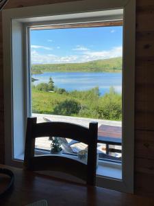 a window with a view of a lake at Mountain Cabin By Hundsåvatnet With Large Veranda in Fannrem