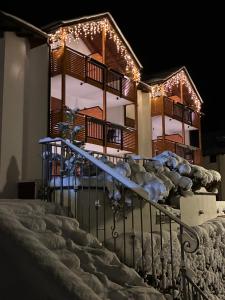 a house with a blue slide in the snow at Residence Cima Tosa in Andalo