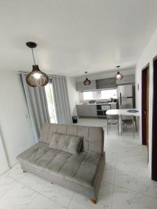 a living room with a couch and a table at Recanto Mar & Sol in Canguaretama