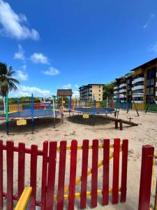 a playground with play equipment on a beach at Resort Flat Gavoa in Igarassu