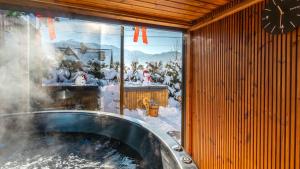 een groot raam van een met sneeuw bedekte kamer met een brandkraan bij Rezydencja Delta Boutique in Kościelisko