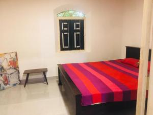 Ένα ή περισσότερα κρεβάτια σε δωμάτιο στο Madiha Dolamulla Gedara