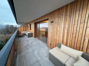 a living room with a couch on a patio at Apartment Sonnenberg in Hallein