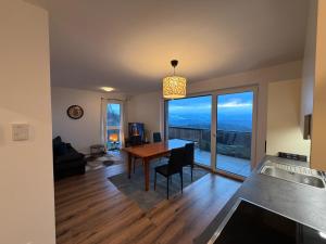 a kitchen and dining room with a table with a view at Apartment Sonnenberg in Hallein