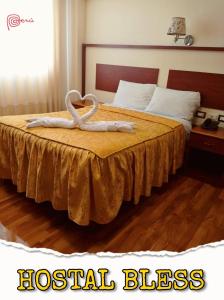 a hotel room with a bed with a towel animal on it at Hostal Bless Tacna in Tacna