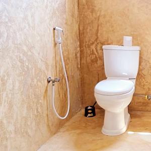 a bathroom with a toilet and a shower at AMOODY MANZIl in Shela +9 photos