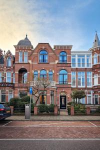 un gran edificio de ladrillo en una calle de la ciudad en Flora's Palace - The Hague Scheveningen, en La Haya