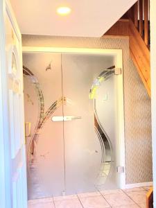 a glass door of a shower with birds on it at Strandresidenz Wittower Heide in Glowe +15 photos