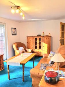 a living room with two couches and a table at Strandresidenz Wittower Heide in Glowe