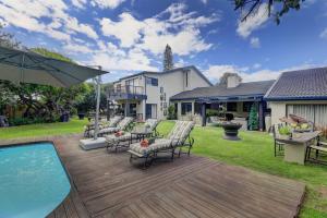 a deck with chairs and a pool in a yard at Stay Wilderness in Wilderness