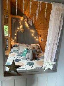 a bedroom with a bed with stars on it at Garden Cottage Glamping Pod in Boncath