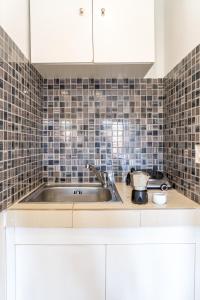 a kitchen with a sink and a counter top at Villa Nikos Koukounaries in Koukounaries