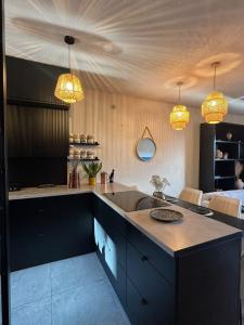 a kitchen with a sink and two lights at BOHO Oasis Radom - Dom z parkingiem in Radom