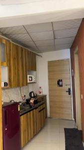 eine Küche mit einer Holztür in einem Zimmer in der Unterkunft GAUR Luxury Stay in Ghaziabad